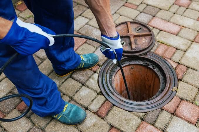 Local plumber accessing a sewer line cleanout to run a camera inspection in Richton Park, IL