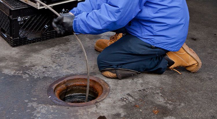Local plumber hydro jetting a grease-packed commercial drain line in Richton Park, IL